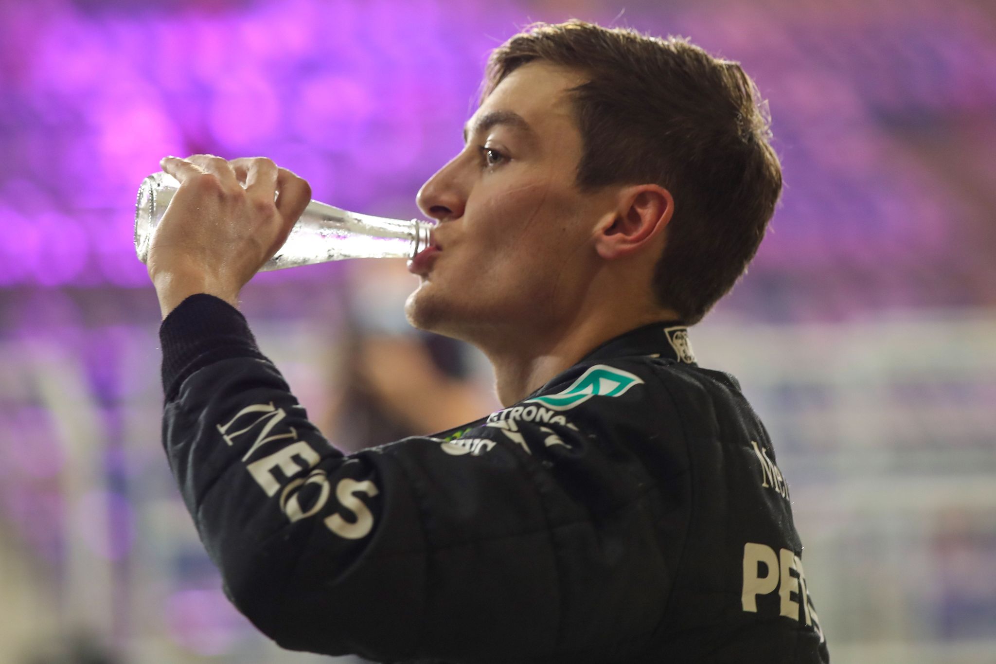 Mercedes British driver George Russell drinks water after the qualifying session ahead of the Sakhir Formula One Grand Prix at the Bahrain International Circuit in the city of Sakhir on December 5, 2020. - Valtteri Bottas claimed pole position for Sundays Sakhir Grand Prix, edging out Mercedes teammate George Russell in qualifying on Saturday in the absence of lt;HIT gt;Lewis lt;/HIT gt; lt;HIT gt;Hamilton lt;/HIT gt;. (Photo by TOLGA BOZOGLU / POOL / AFP)