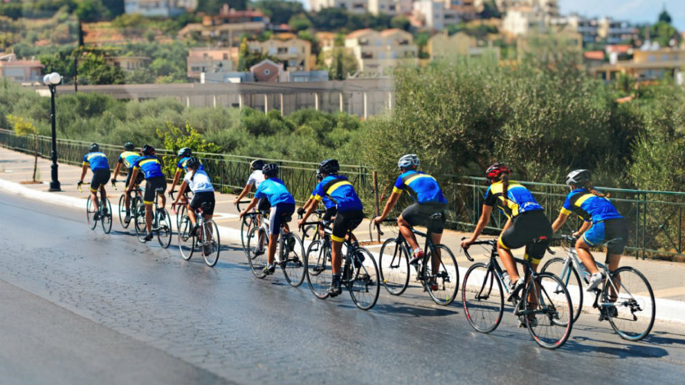 Un grupo de ciclistas circula en paralelo por una vía fuera de poblado.