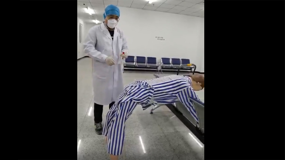 Chinese health worker shows how the anal swab coronavirus test works