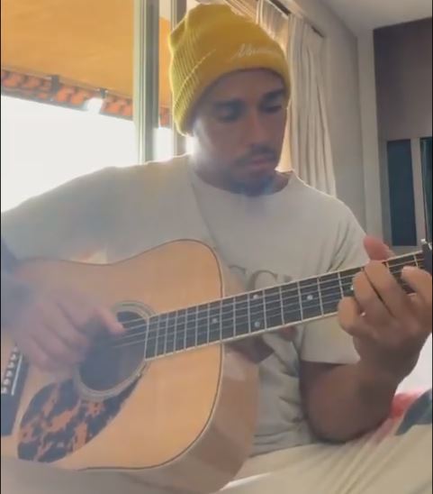 Hamilton playing guitar