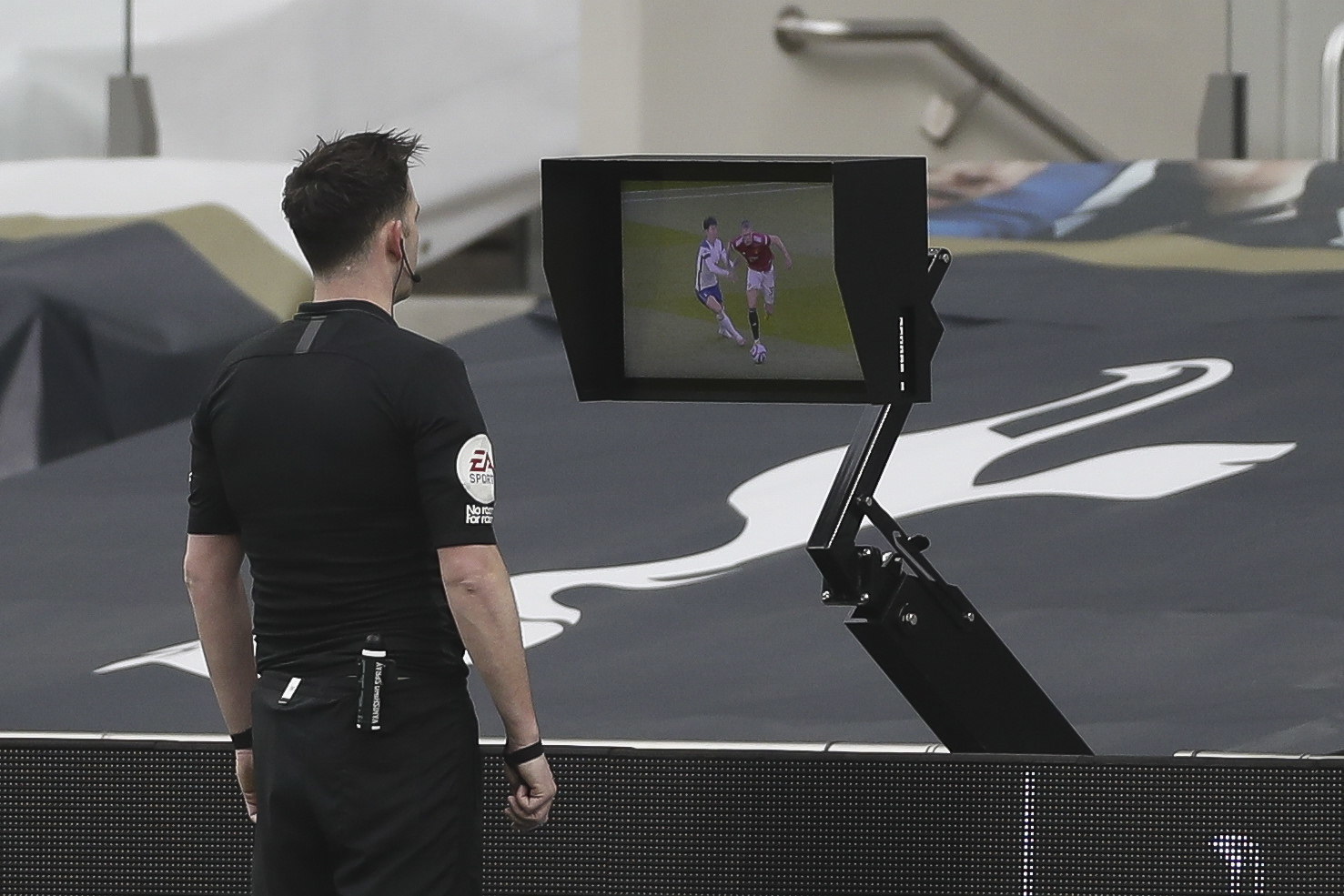 Referee Chris Kavanagh checks the Video Assistant Referee (VAR) System