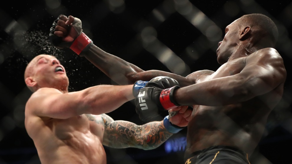 Israel Adesanya lands a hit against Marvin Vettori during UFC 263.