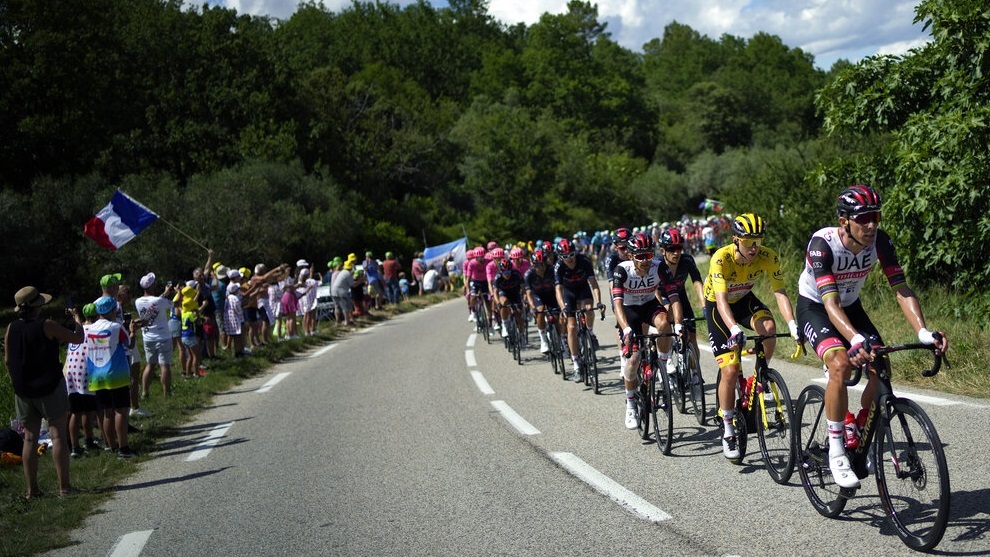 Slovenia's Tadej Pogacar, wearing the overall leader's yellow jersey, rides with the pack during the twelfth stage of the Tour de France.