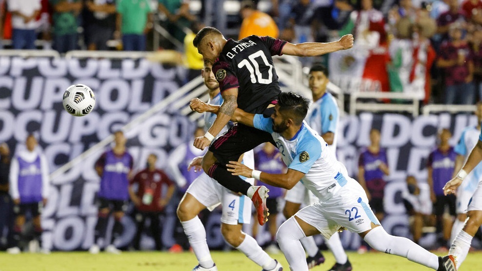 Mexico midfielder Orbelin Pineda (10) scores as he is defended by Guatemala defender Jose Morales (22).