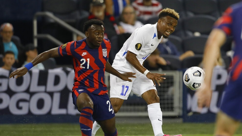 Martinique's Patrick Burner (17) clears the ball as United States' George Bello (21) pressures.