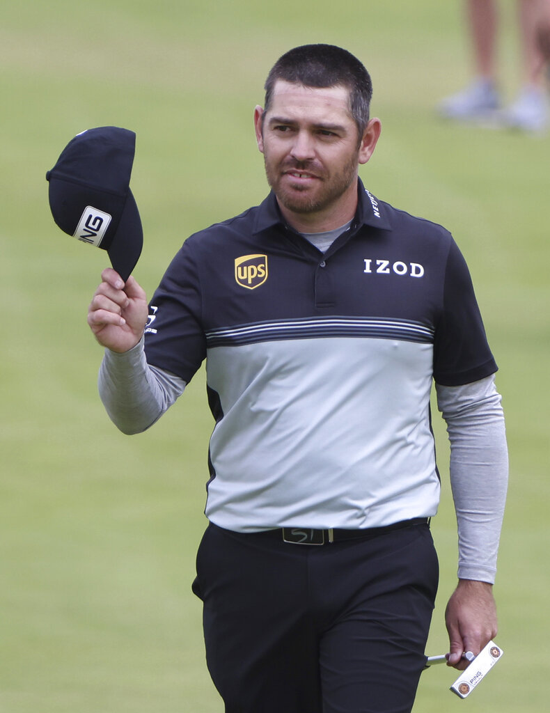 South Africa's Louis Oosthuizen acknowledges the crowd as he walks onto the 18th green.