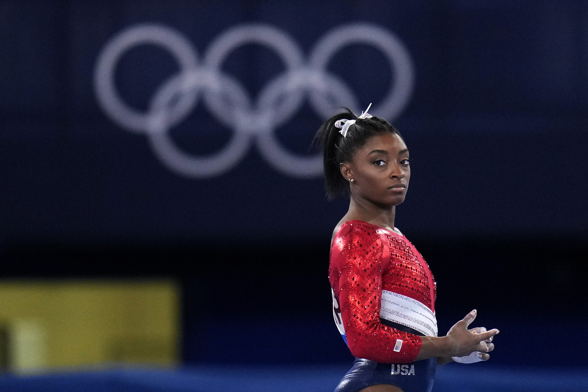 File-This July 27, 2021, file photo shows Simone lt;HIT gt;Biles lt;/HIT gt;, of the United States, waiting to perform on the vault during the artistic gymnastics women's final at the 2020 Summer Olympics, Tuesday, July 27, 2021, in Tokyo. lt;HIT gt;Biles lt;/HIT gt;' sponsors including Athleta and Visa are lauding her decision to put her mental health first and withdraw from the gymnastics team competition during the Olympics. It's the latest example of sponsors praising athletes who are increasingly open about mental health issues. (AP Photo/Gregory Bull, File)