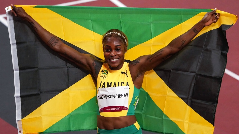 Elaine Thompson-Herah, of Jamaica, celebrates after winning the women's 100-meter final.
