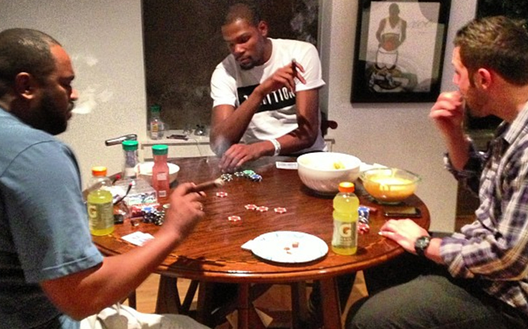Kevin Durant, fumándose un puro mientras juega al póker con unos amigos.