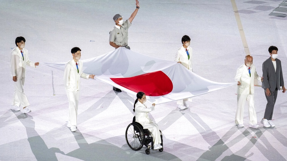 Athletes from Japan carry the national flag of Japan into the Olympic Stadium.