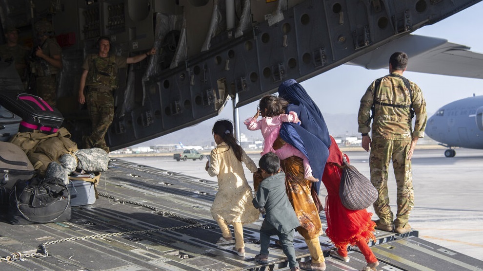 .S. Air Force loadmasters and pilots load people being evacuated from Afghanistan.