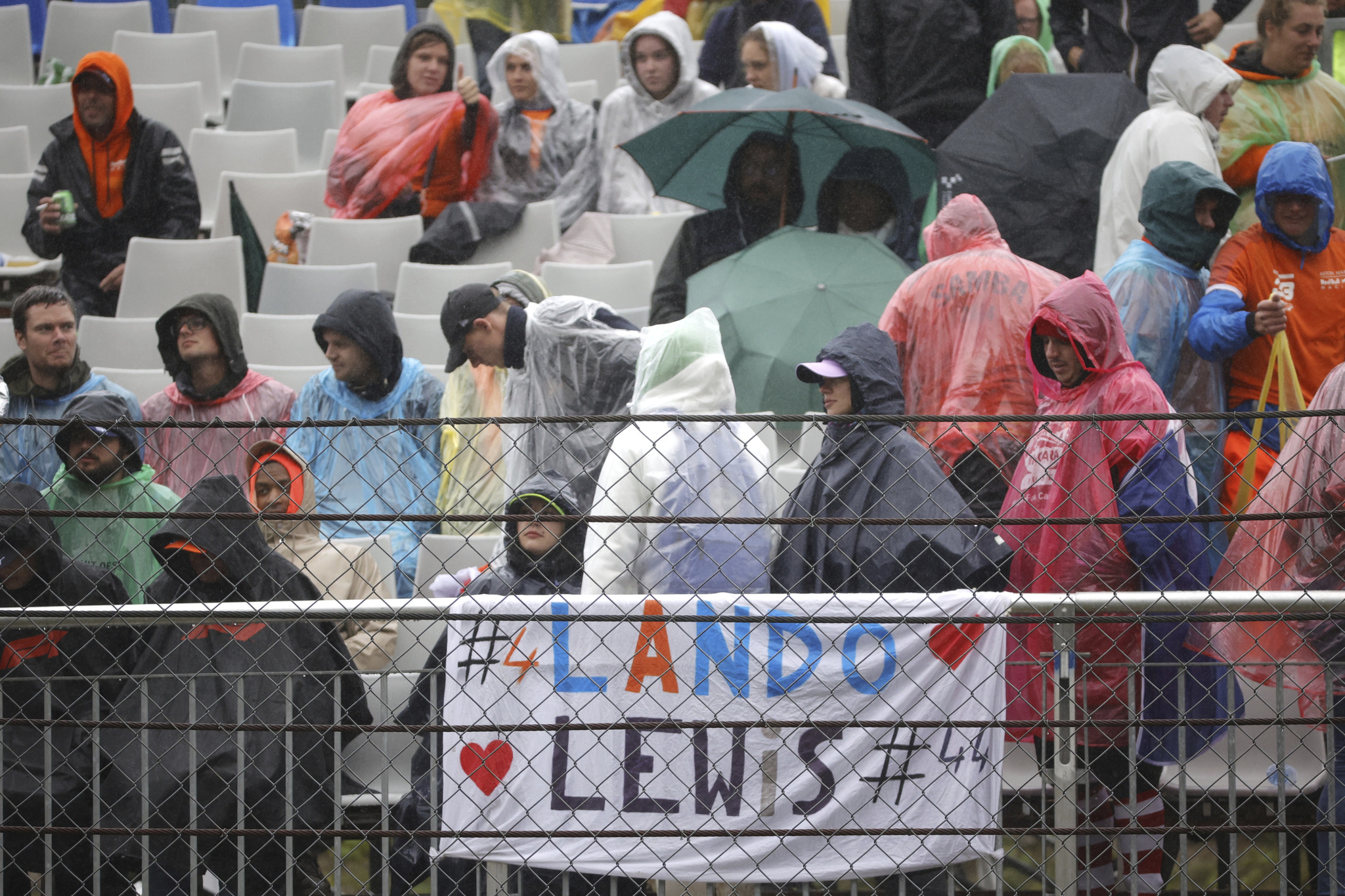 Spectators wait in the stands during a rain delay at the Formula One Grand Prix at the lt;HIT gt;Spa lt;/HIT gt;-Francorchamps racetrack in lt;HIT gt;Spa lt;/HIT gt;, Belgium, Sunday, Aug. 29, 2021. (AP Photo/Olivier Matthys)