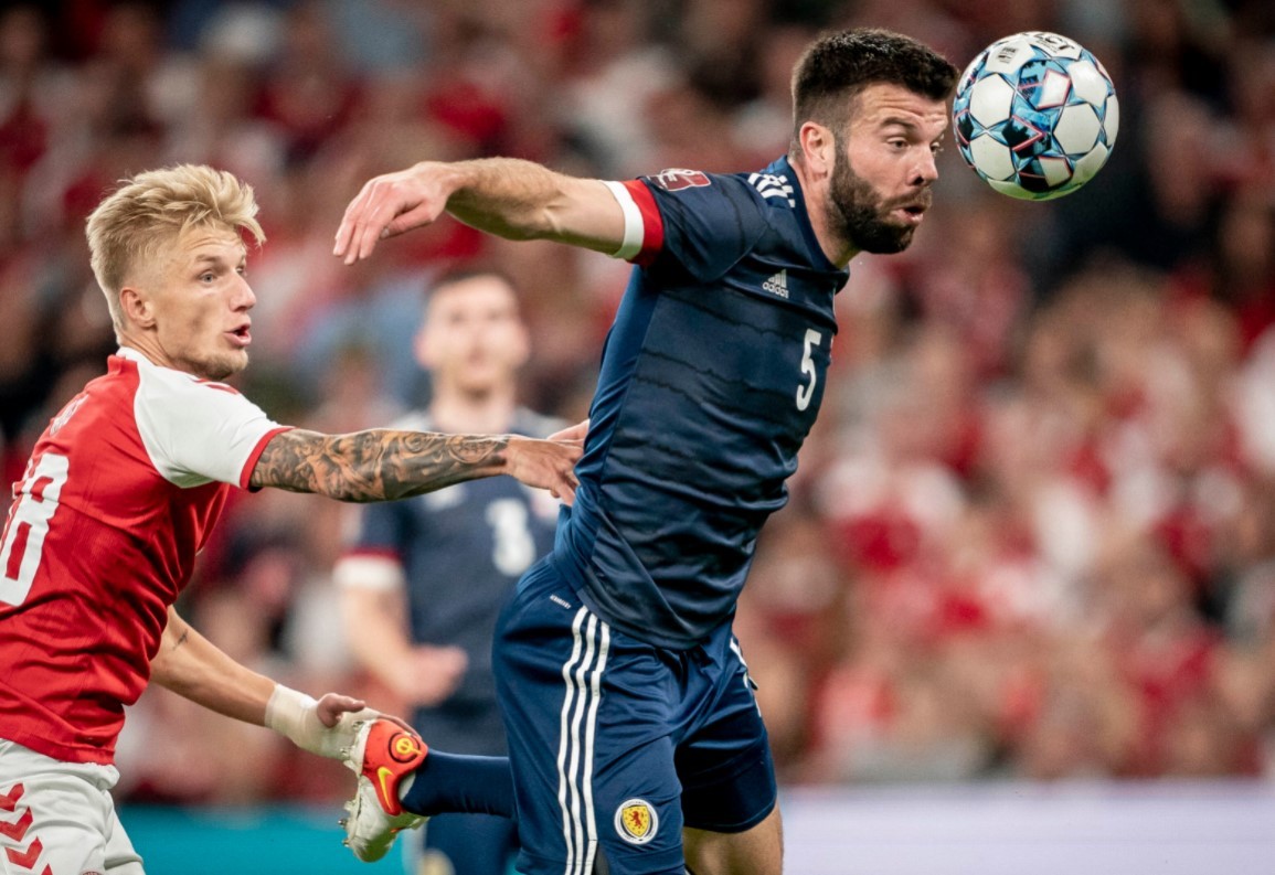 Wass puts pressure on Scottish player Grant Hanley in the World Cup qualifier.