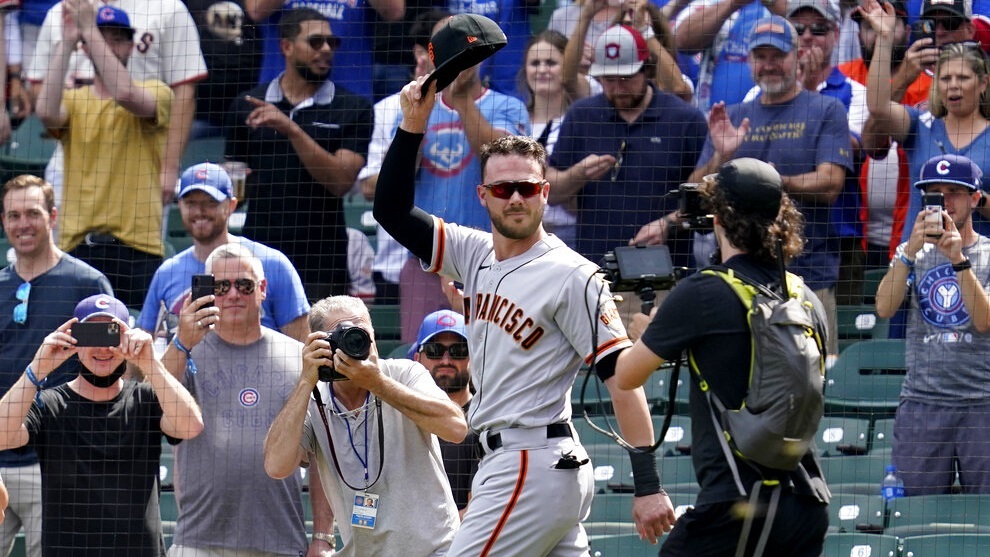 San Francisco Giants Kris Bryant greets Chicago Cubs fans as he walks to the dugout before a baseball game.