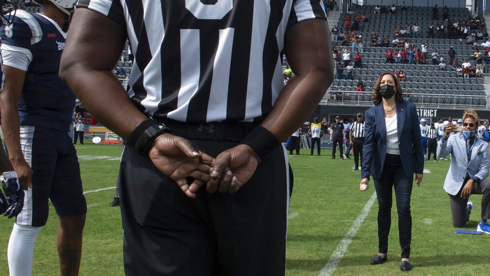 Vice President Kamala Harris takes part in the ceremonial coin toss before an NCAA college football game between Howard and Hampton in Washington.