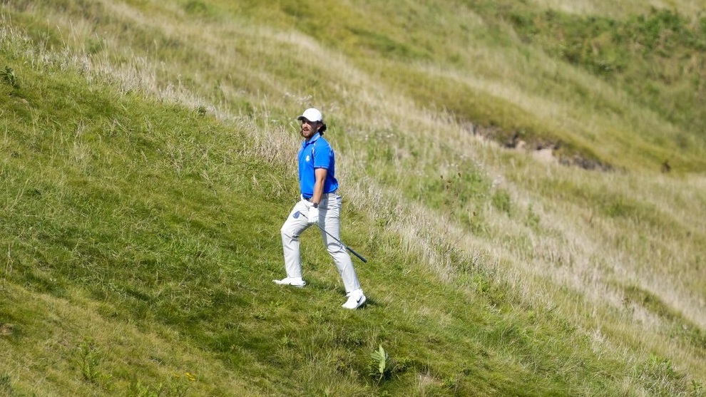 Team Europe's Tommy Fleetwood looks at his shot on the fourth hole during a four-ball match.