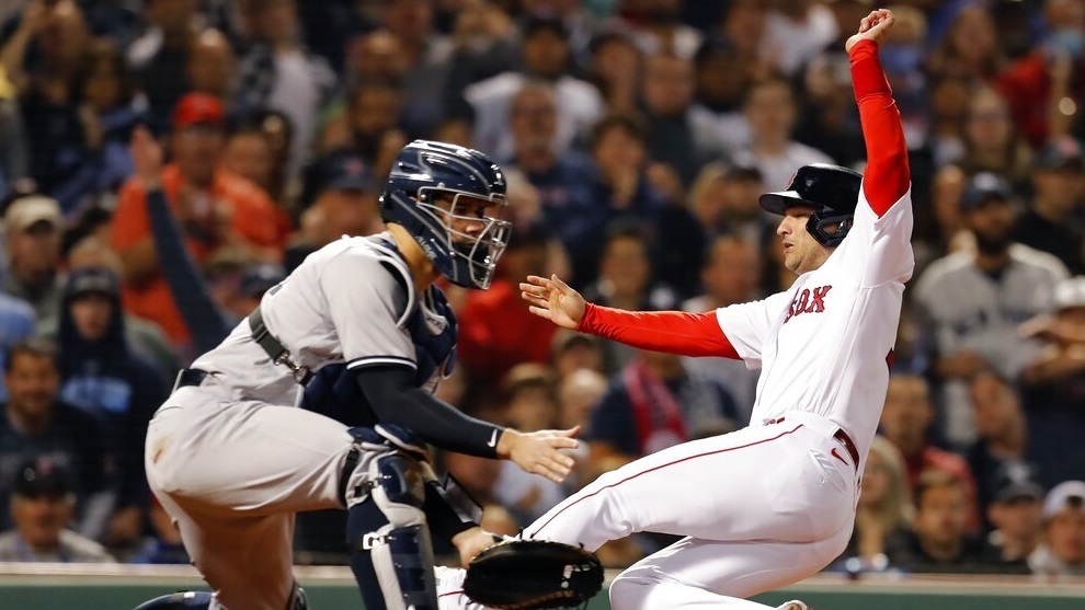 Boston Red Sox's Jose Iglesias scores ahead of the throw to New York Yankees' Gary Sanchez.