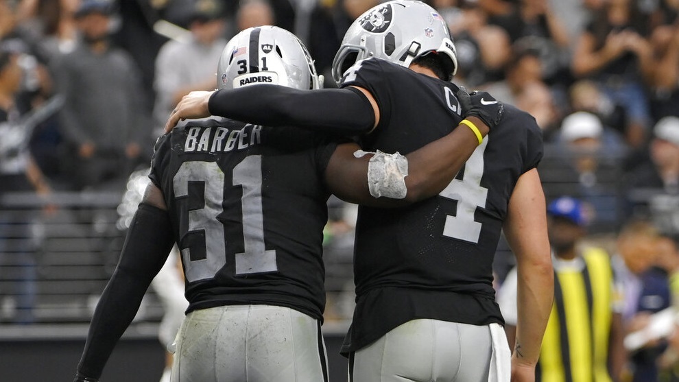 Peyton Barber (31) and quarterback Derek Carr (4) celebrate after Barber scored a touchdown.