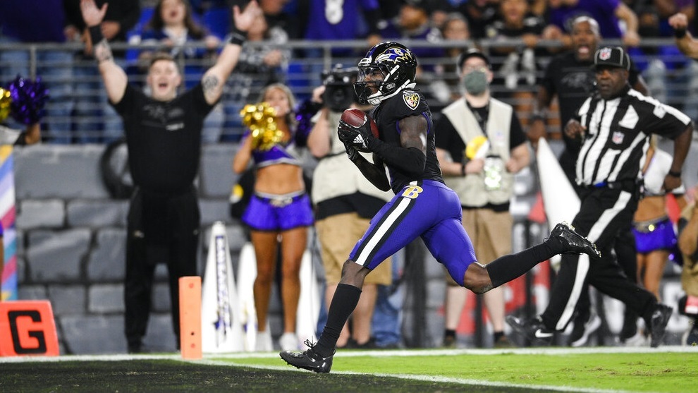 Baltimore Ravens wide receiver Marquise Brown, center, scores a touchdown.