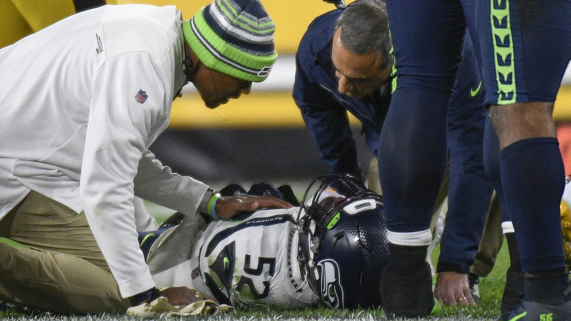 Darrell Taylor (52) lays on the ground and is tended after being injured.