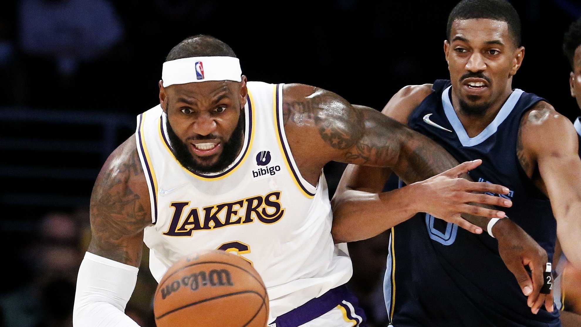 Los Angeles Lakers forward LeBron James, left, and Memphis Grizzlies guard De'Anthony Melton.