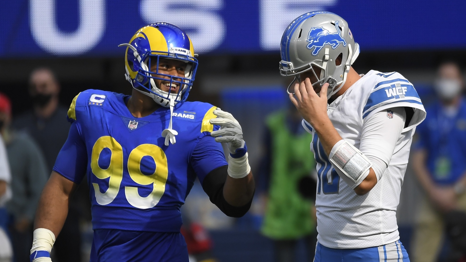 Detroit Lions quarterback Jared Goff talks with Los Angeles Rams defensive end Aaron Donald.