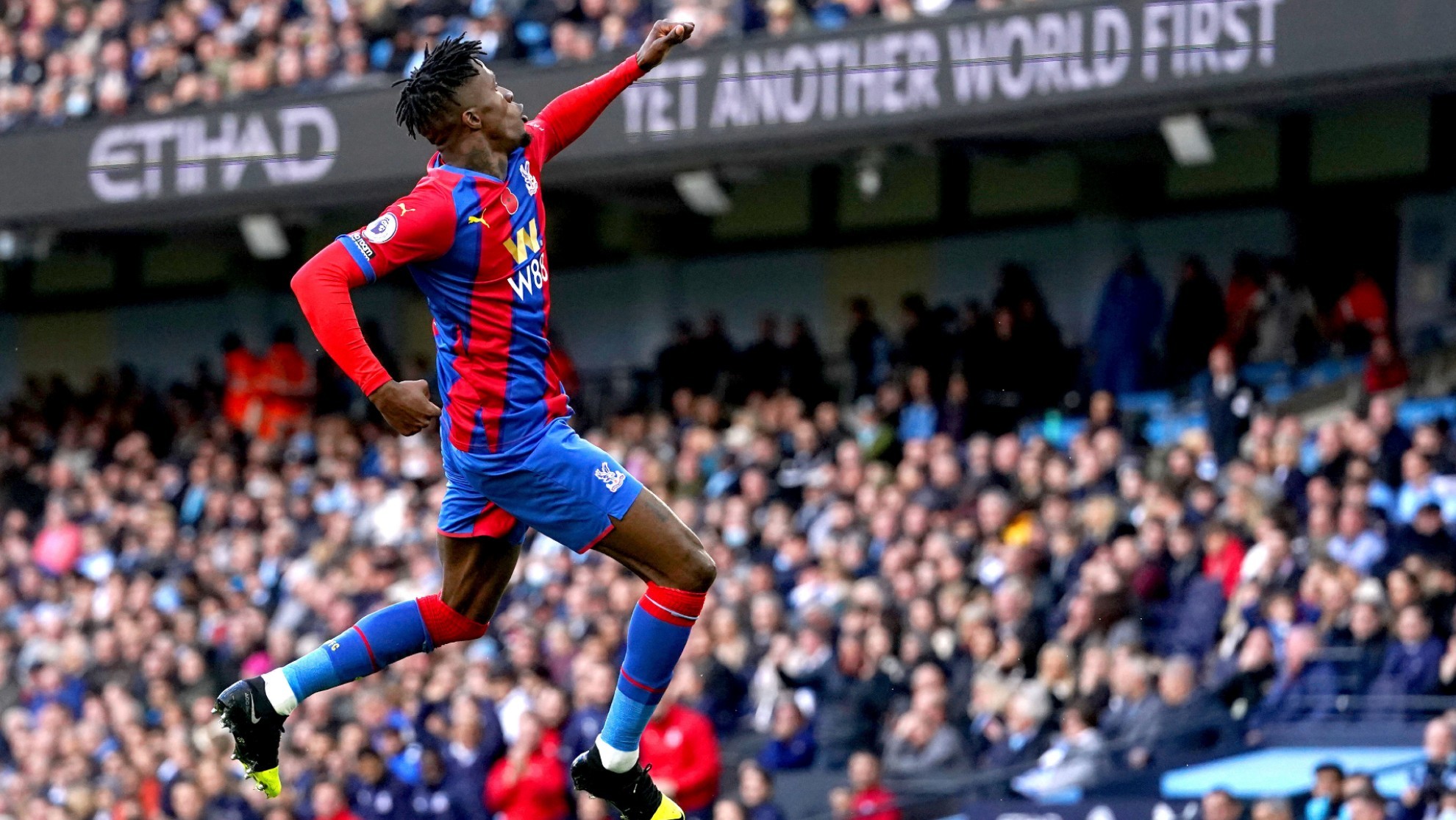 Wilfried Zaha celebrates scoring during the English Premier League soccer match between City and Crystal Palace