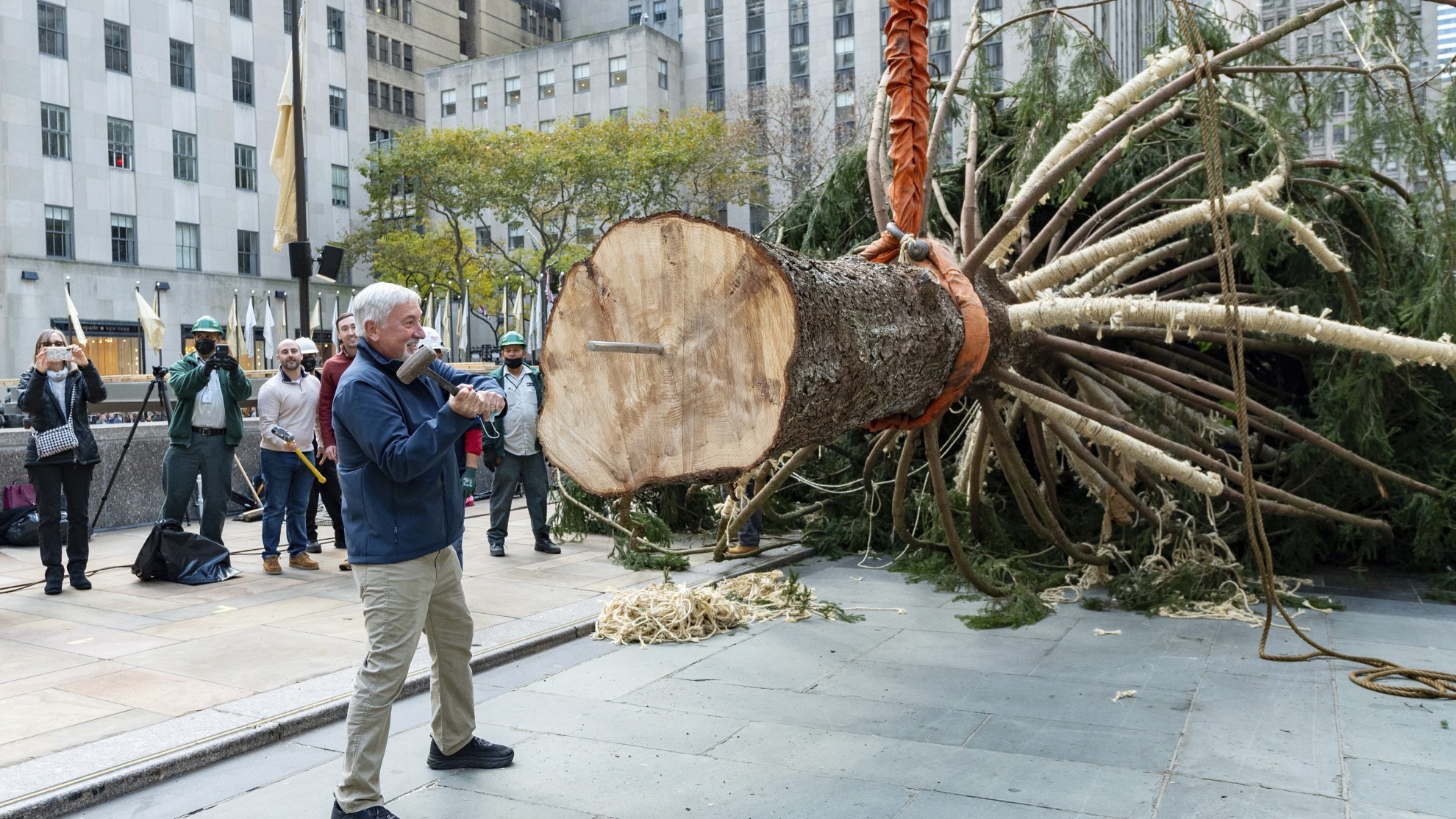 Tree donor Devon Price drives a spike into the trunk of the 79-foot tall.