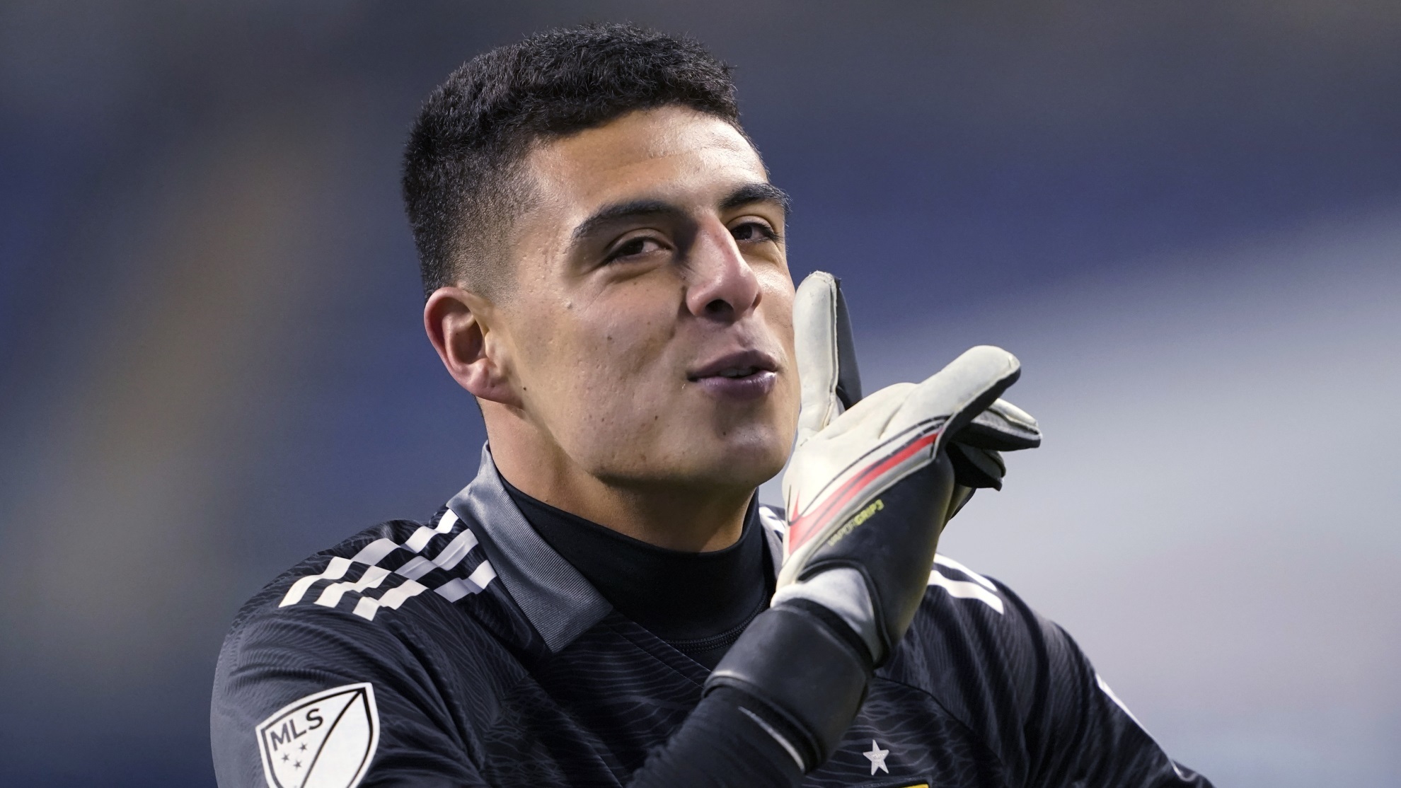 Real Salt Lake goalkeeper David Ochoa motions to fans in a gesture to quiet.