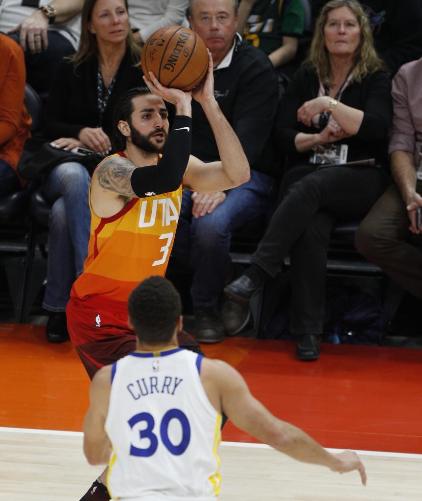 Ricky Rubio, durante su época en los Suns, lanza delante de Stephen Curry.