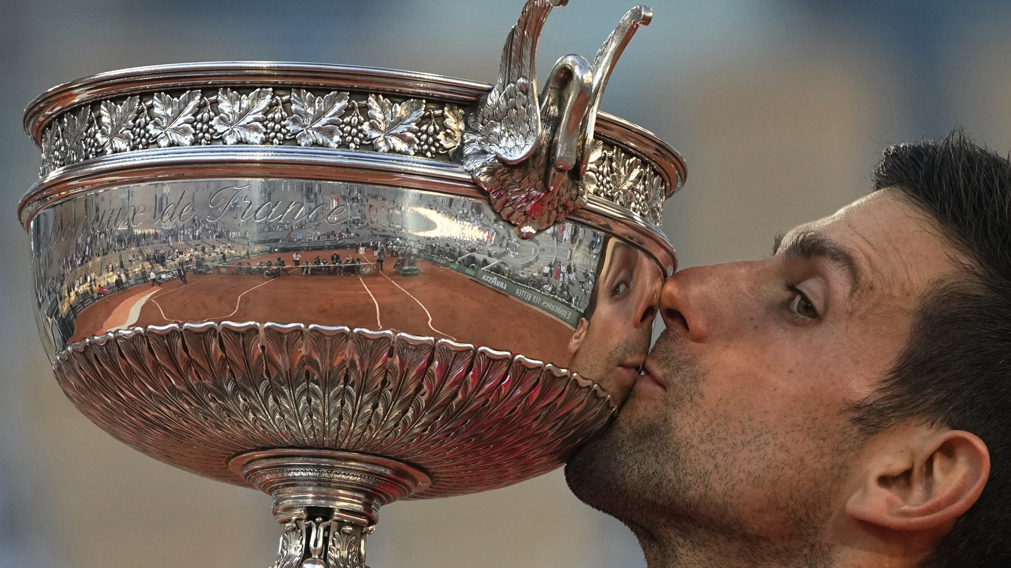Novak Djokovic kisses the cup of the French Open at the Roland Garros stadium, June 13, 2021 in Paris.