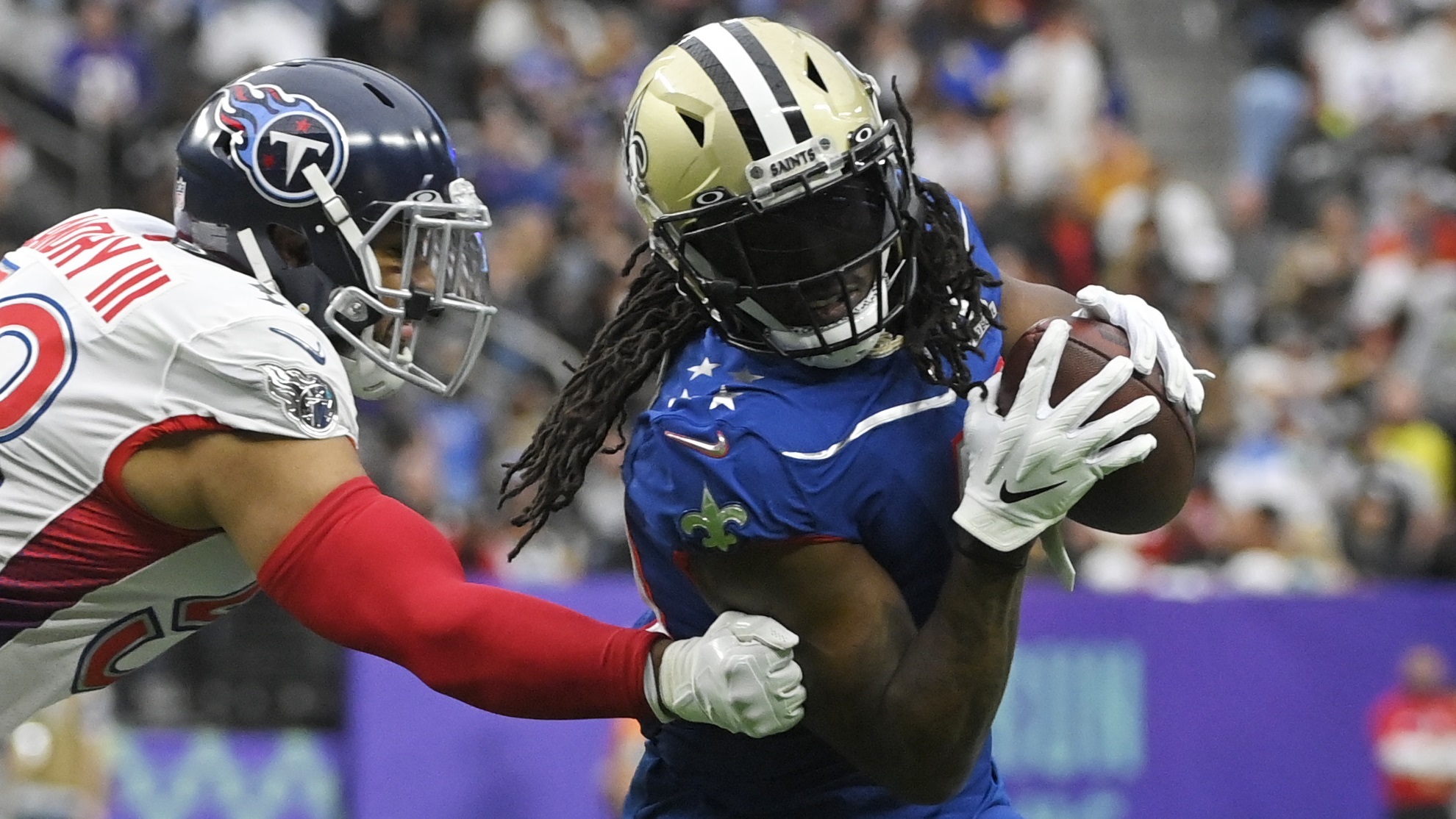 Alvin Kamara (41) rushes against Harold Landry (58) during the first half of the Pro Bowl NFL football game.