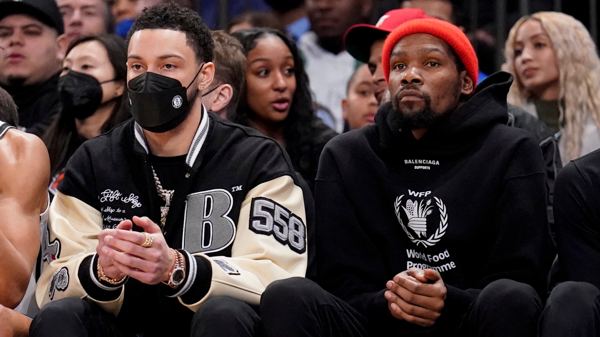 Brooklyn Nets forward Ben Simmons, left, sits with forward Kevin Durant.