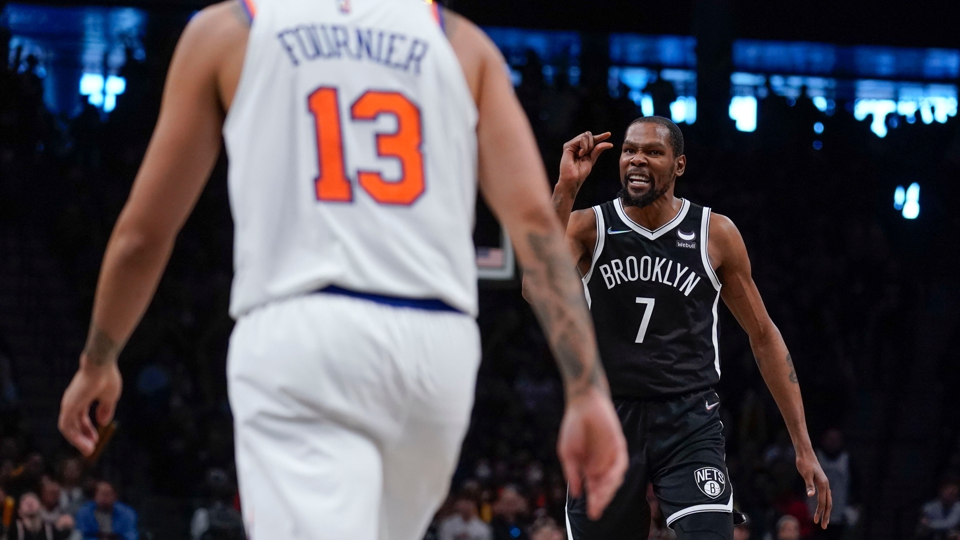 Brooklyn Nets' Kevin Durant, right, reacts after hitting a basket during the second half of the NBA basketball game against the New York Knicks