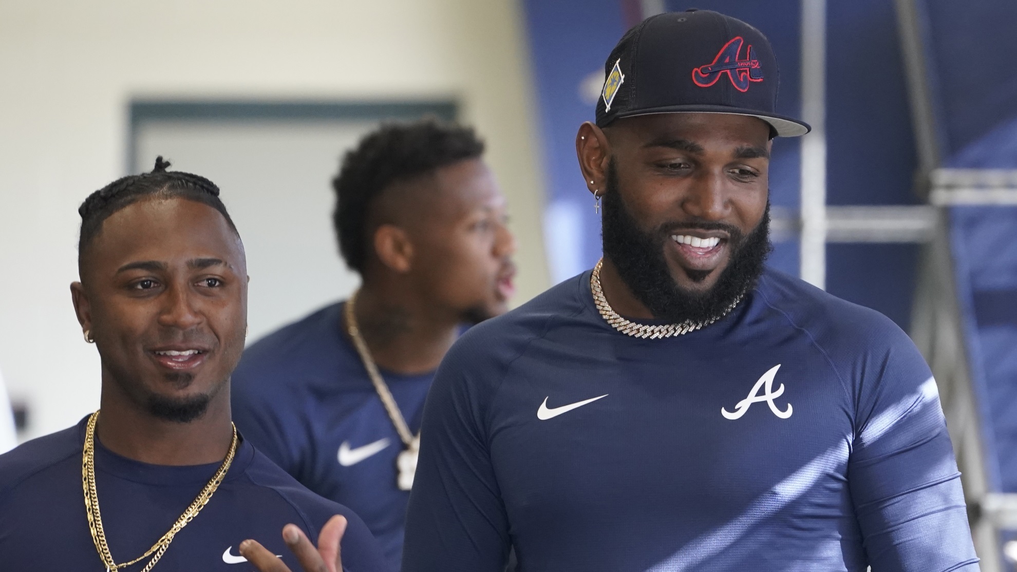 Marcell Ozuna talks to teammate Ozzie Alvies in the batting cages during spring training baseball.