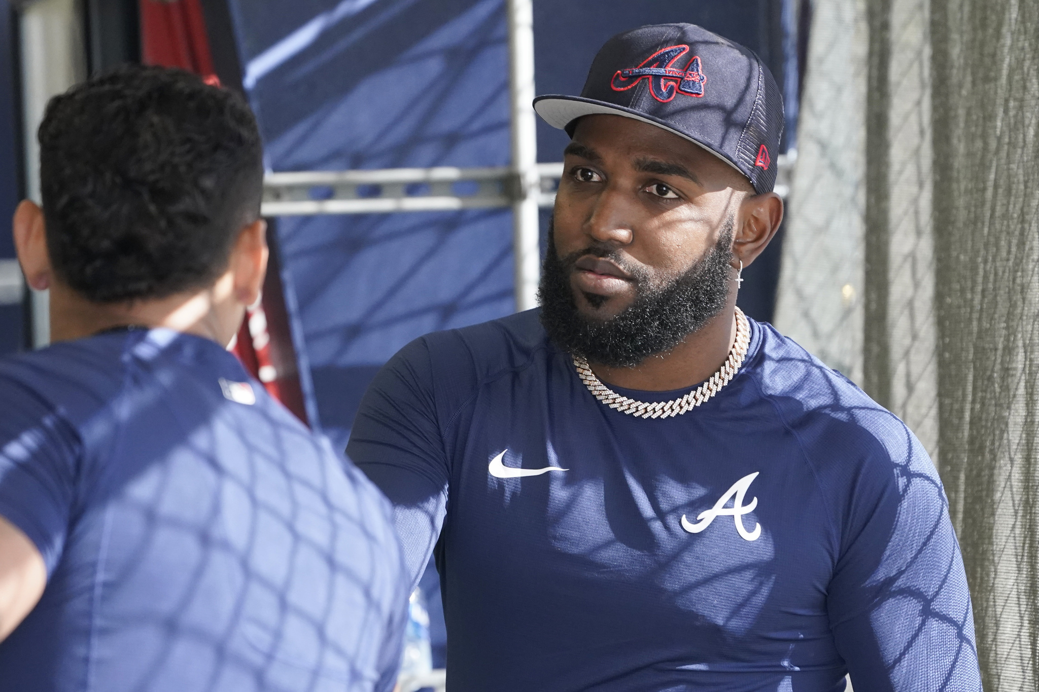 Marcell Ozuna talks to a teammate in the batting cages during spring training baseball practice at CoolToday Park.