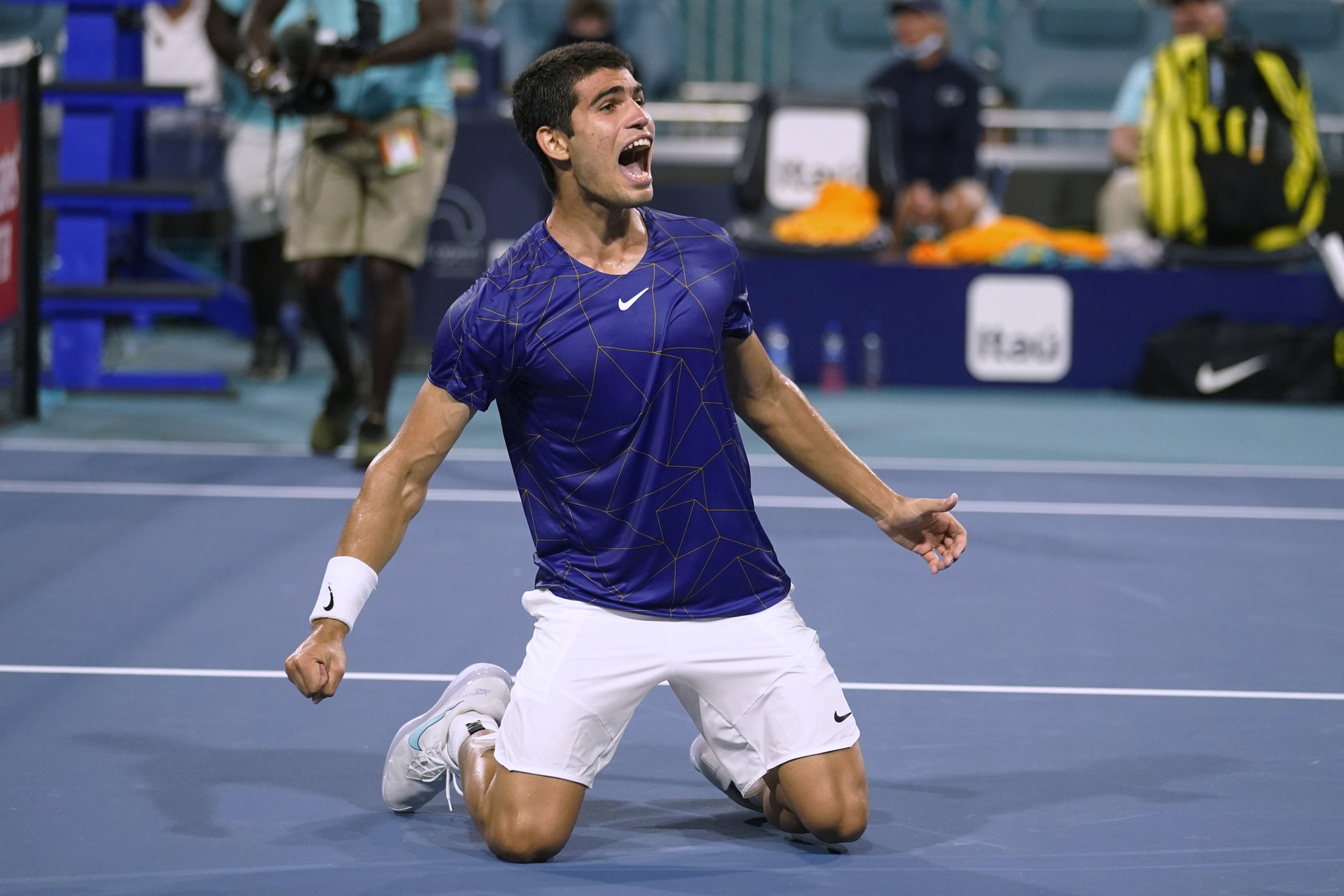 Carlos lt;HIT gt;Alcaraz lt;/HIT gt;, of Spain, kneels on the court after defeating Miomir Kecmanovic, of Serbia, during the Miami Open tennis tournament Thursday, March 31, 2022, in Miami Gardens, Fla. (AP Photo/Marta Lavandier)