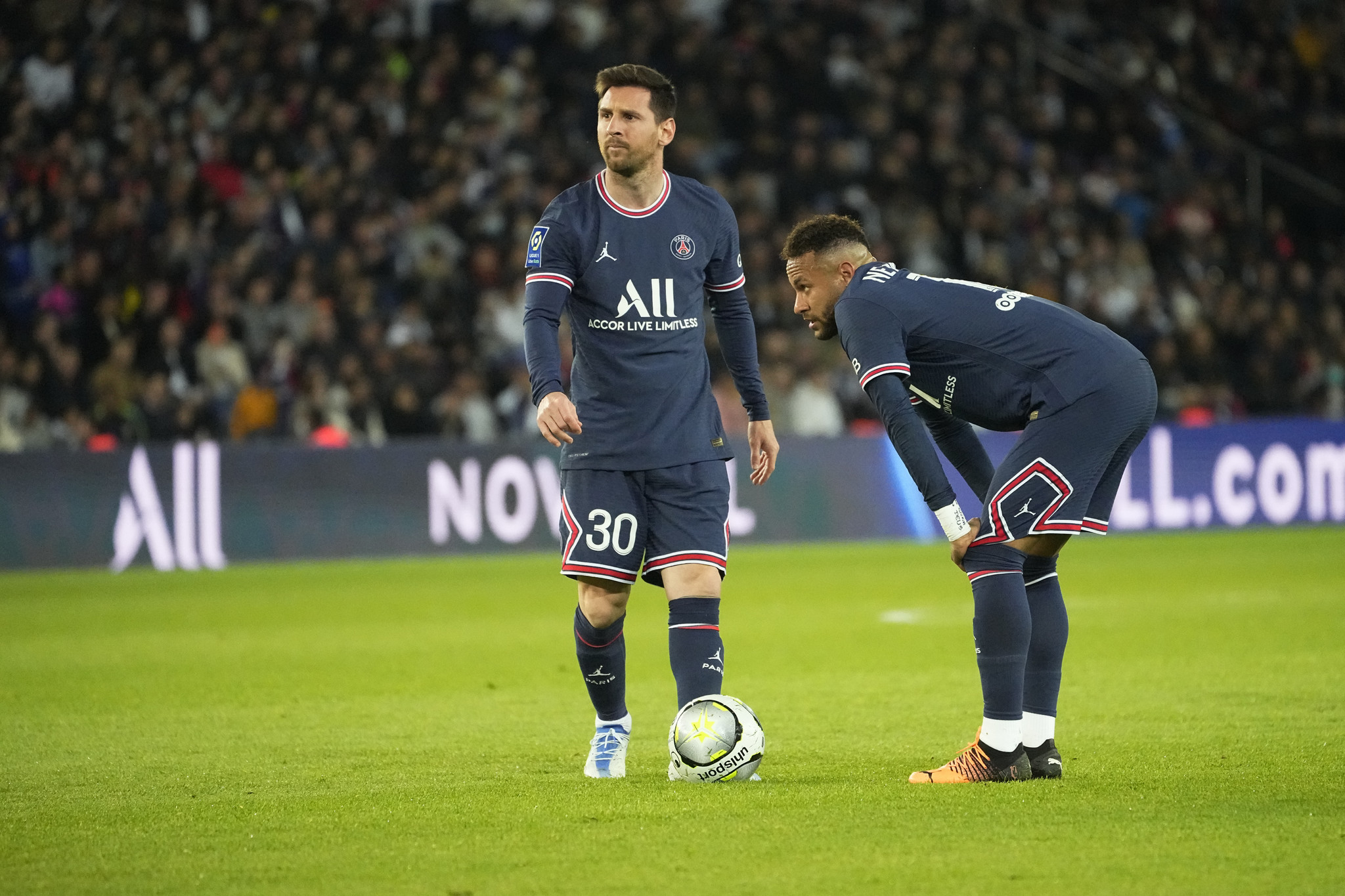 PSG's Lionel Messi, left, and PSG's Neymar prepare to shot a free kick.