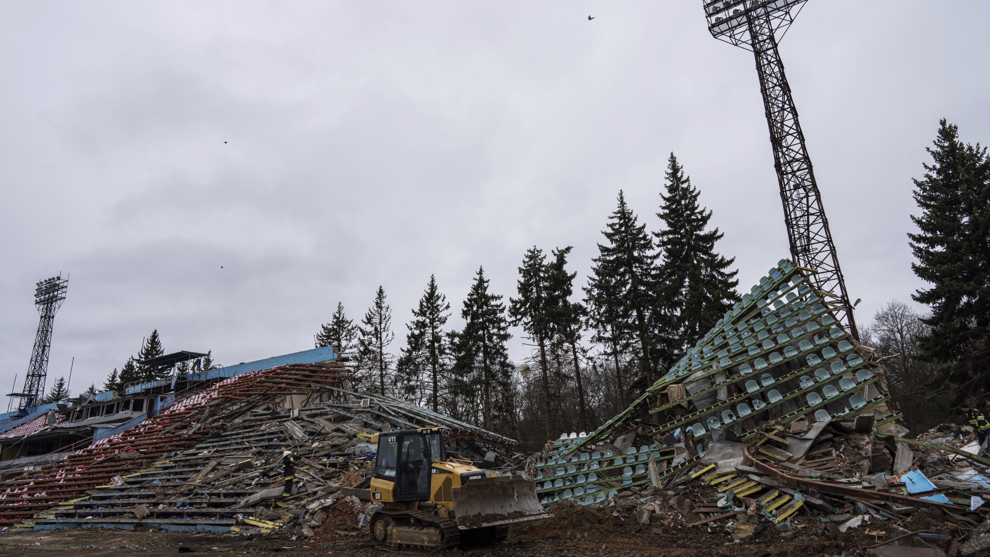 A bulldozer works at a central stadium damaged by Russian forces' shelling in Chernihiv, Ukraine.