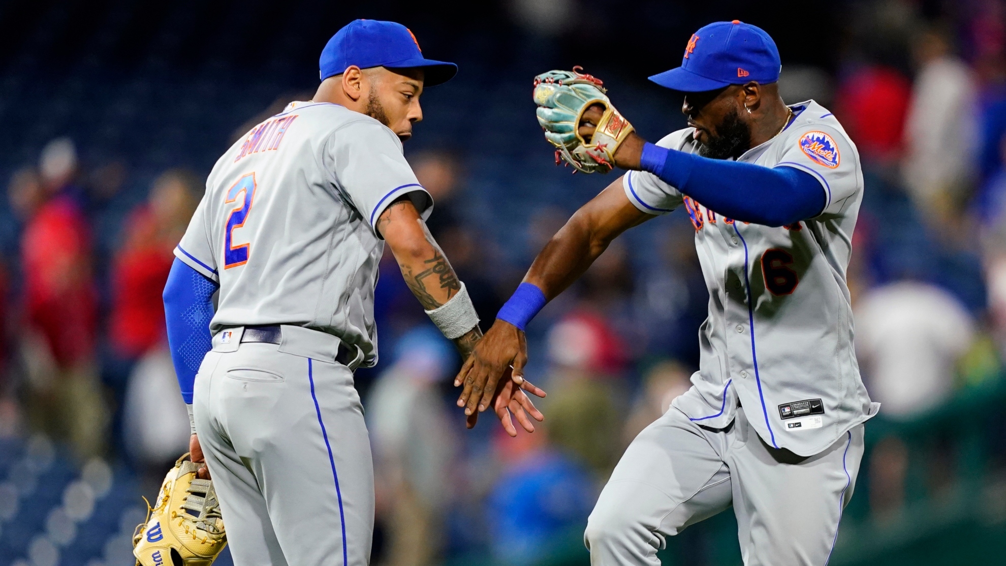 New York Mets' Dominic Smith and Starling Marte celebrate after a baseball game against the Phillies,