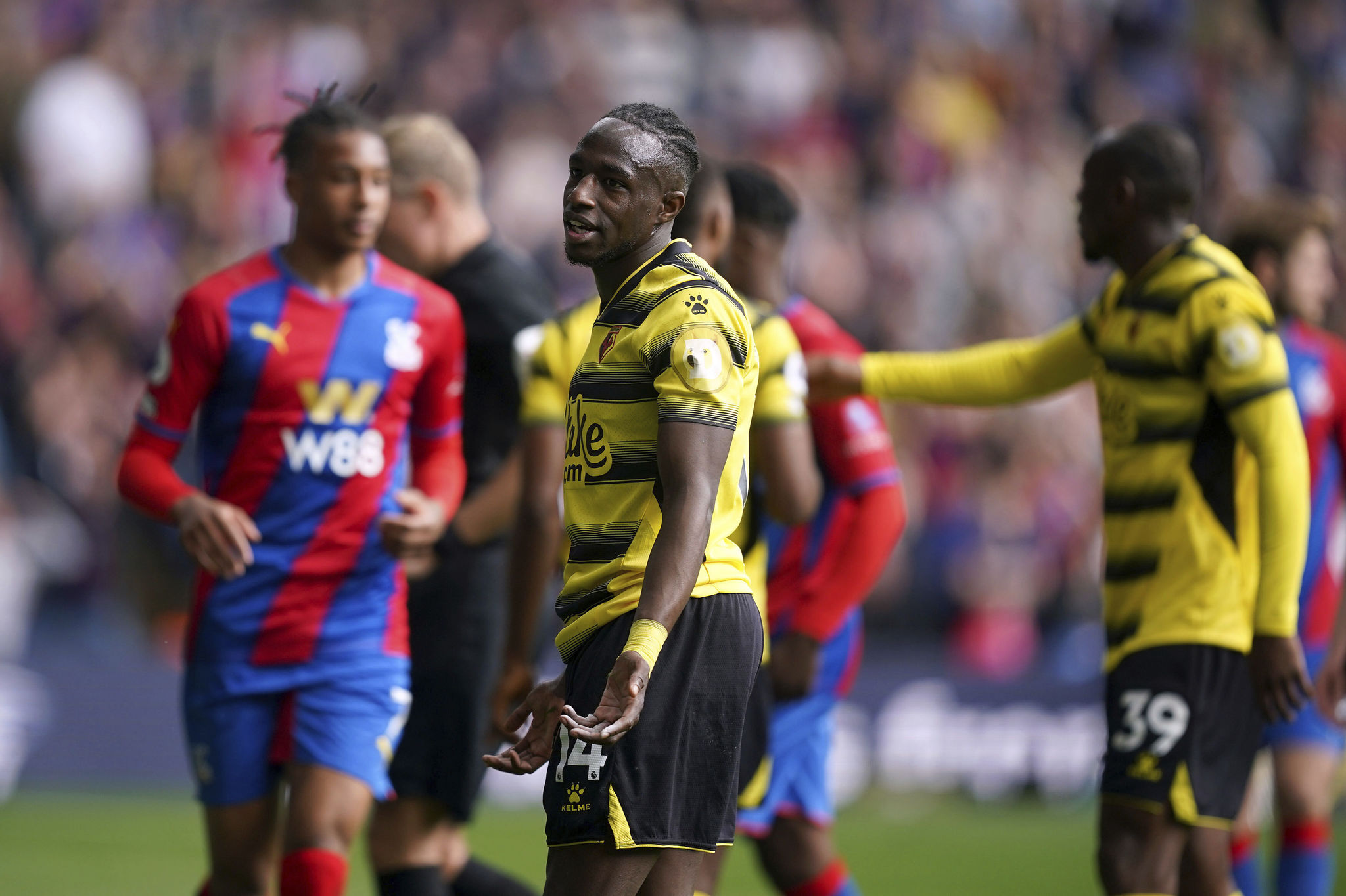 Watford's Hassane Kamara reacts to being shown a red card.