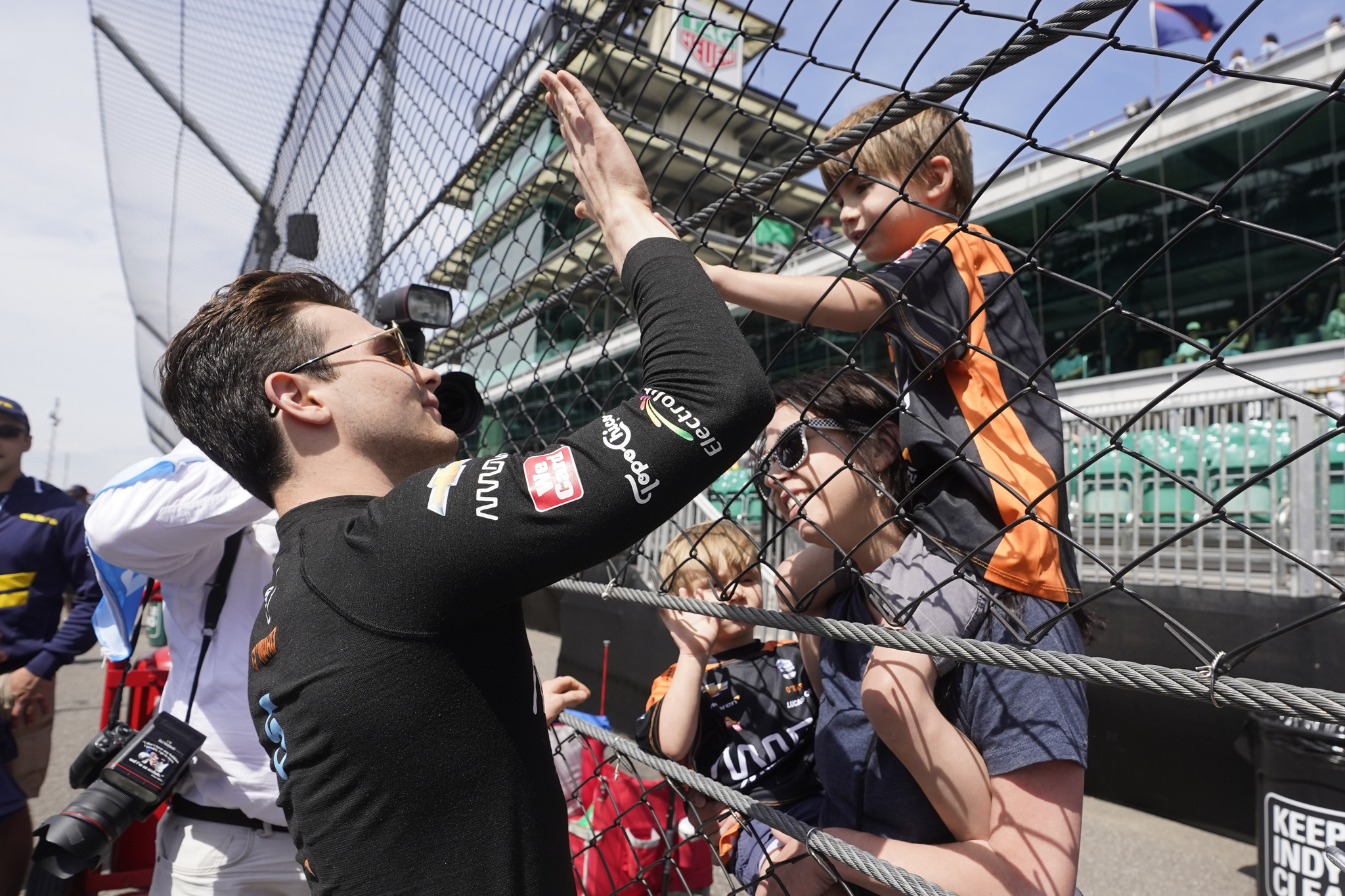 Pato O'Ward, left, of Mexico, gets a high-five from a fan before qualifications for the Indianapolis 500.