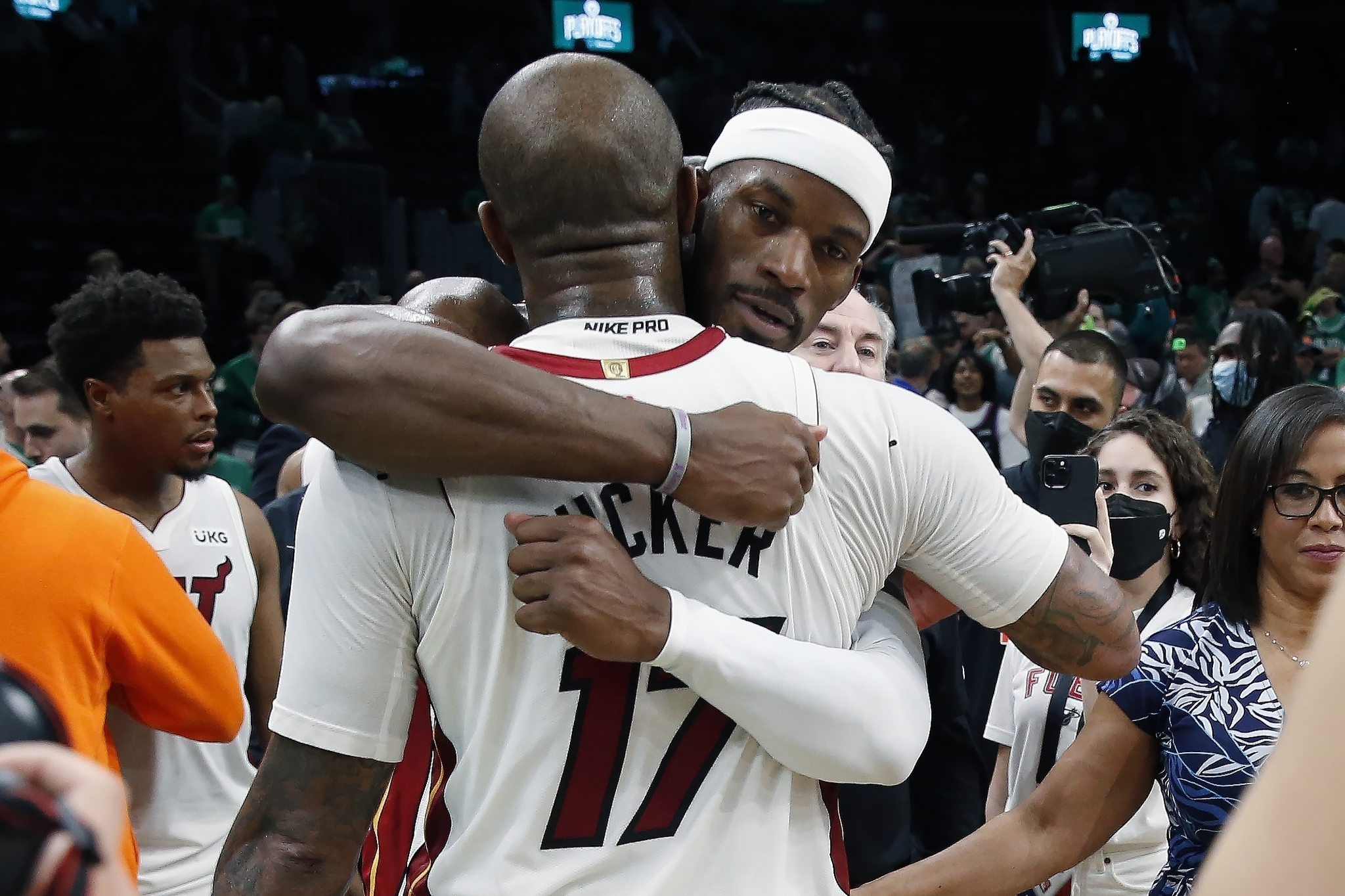 Miami Heat's Jimmy Butler hugs P.J. Tucker (17) after the Heat defeated the Boston Celtics 111-103.