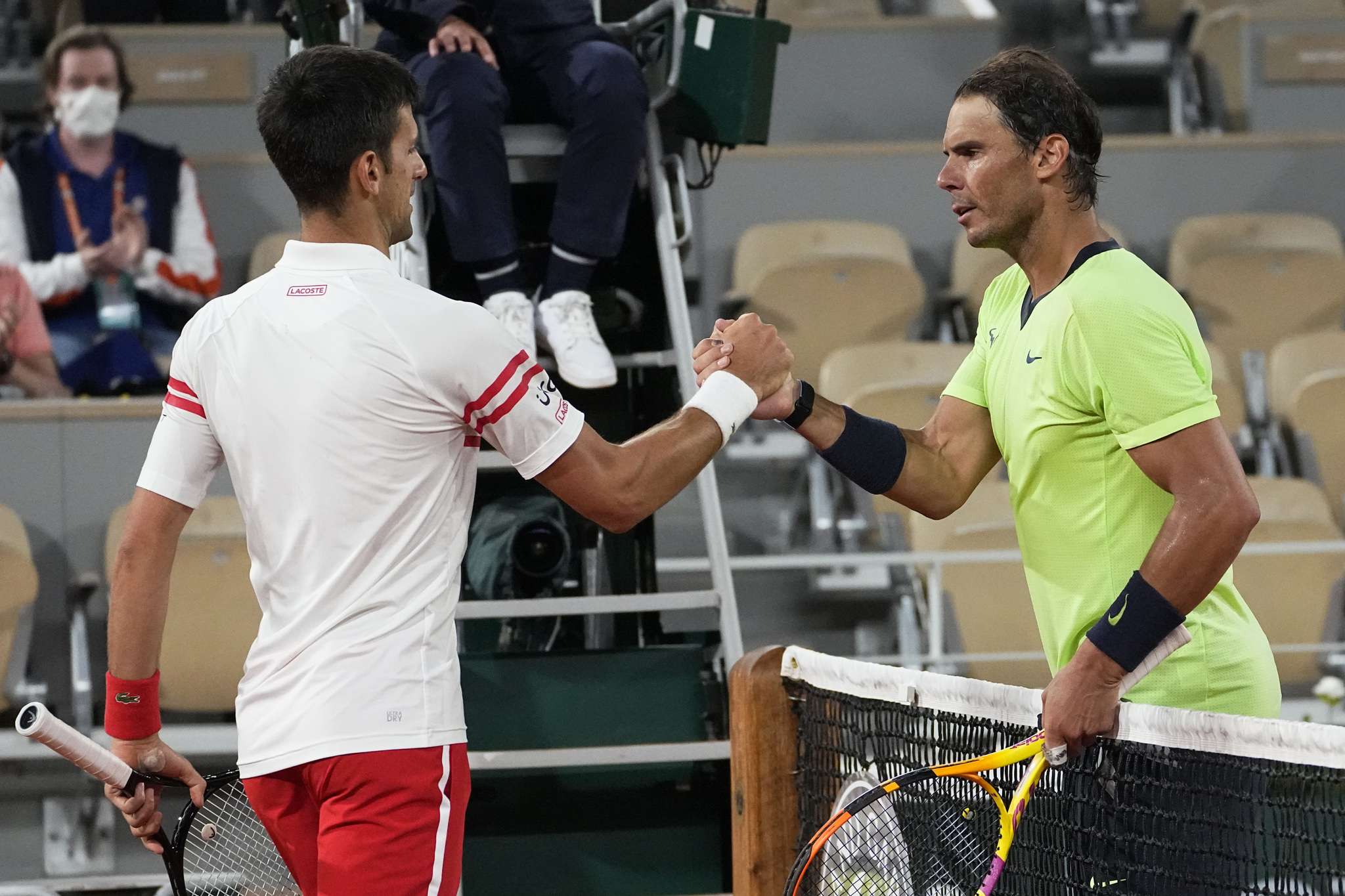 Serbia's Novak Djokovic, shakes hands with Spain's Rafael Nadal