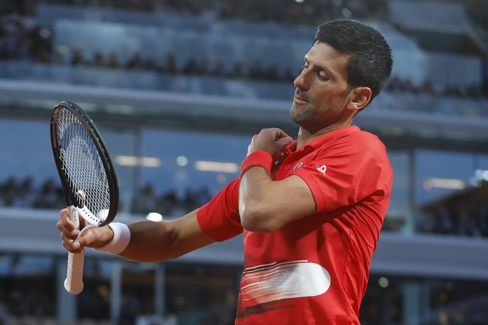 Serbia's Novak Djokovic looks at his racket as he plays Spain's Rafael  lt;HIT gt;Nadal lt;/HIT gt; during their quarterfinal match of the French Open tennis tournament at the Roland Garros stadium Tuesday, May 31, 2022 in Paris. (AP Photo/Jean-Francois Badias)