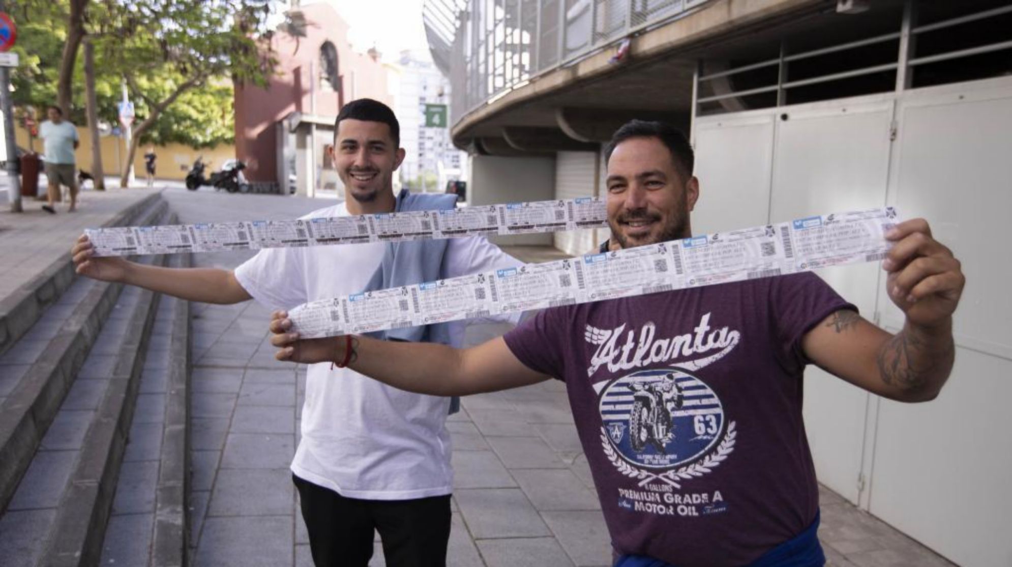 Two fans, exultant after buying several seats for Tenerife-Girona