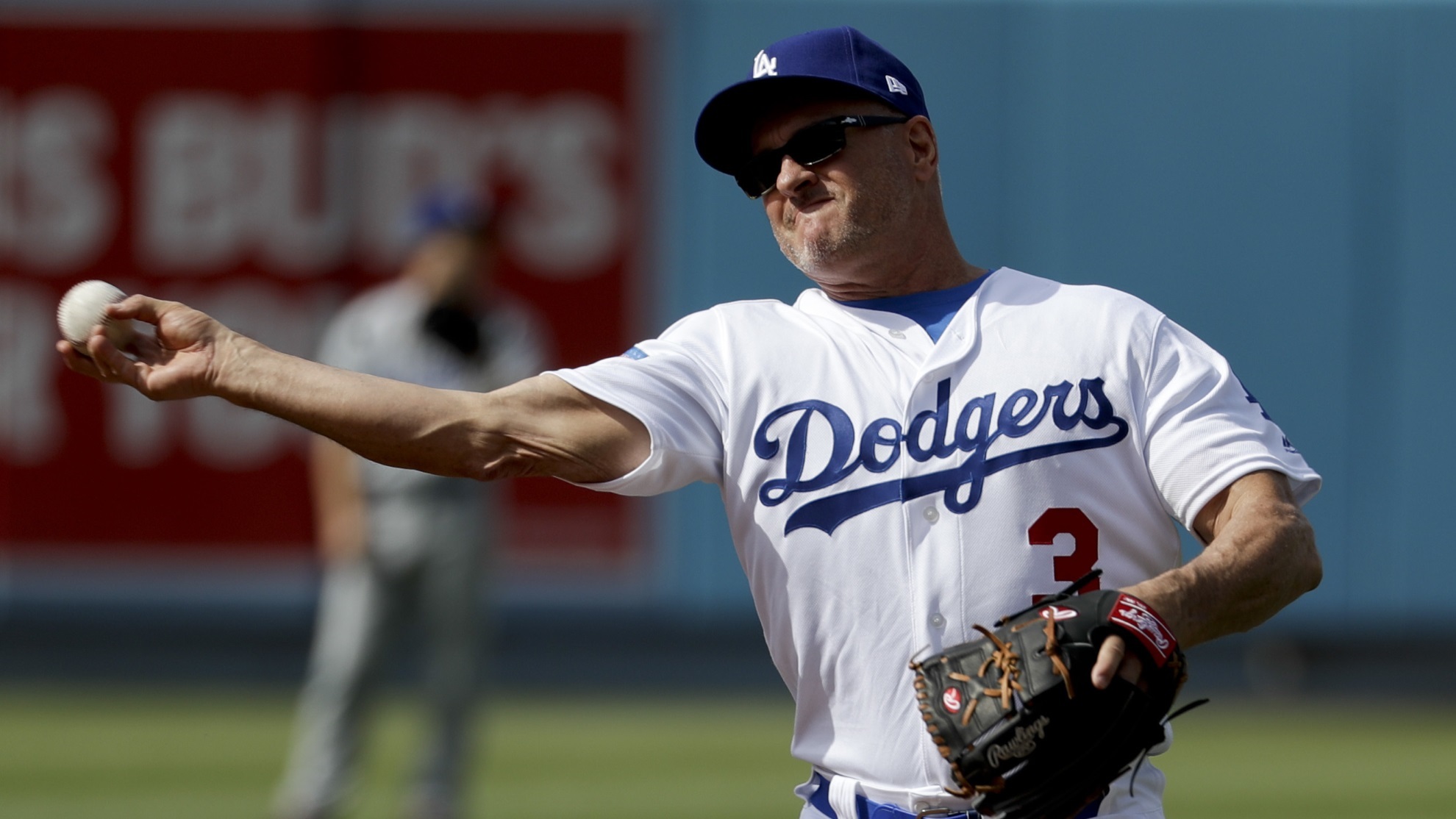 Former LA Dodger Steve Sax throws after fielding a ball during batting practice before an old-timers game.