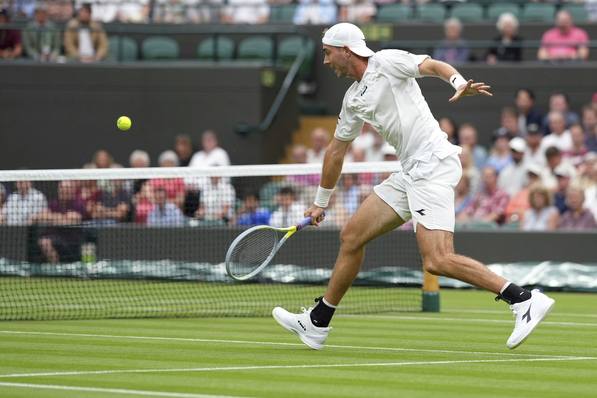 Germany's Jan-Lennard  lt;HIT gt;Struff lt;/HIT gt; returns the ball to Spain's Carlos Alcaraz during their men's singles tennis match on day one of the Wimbledon tennis championships in London, Monday, June 27, 2022. (AP Photo/Alberto Pezzali)
