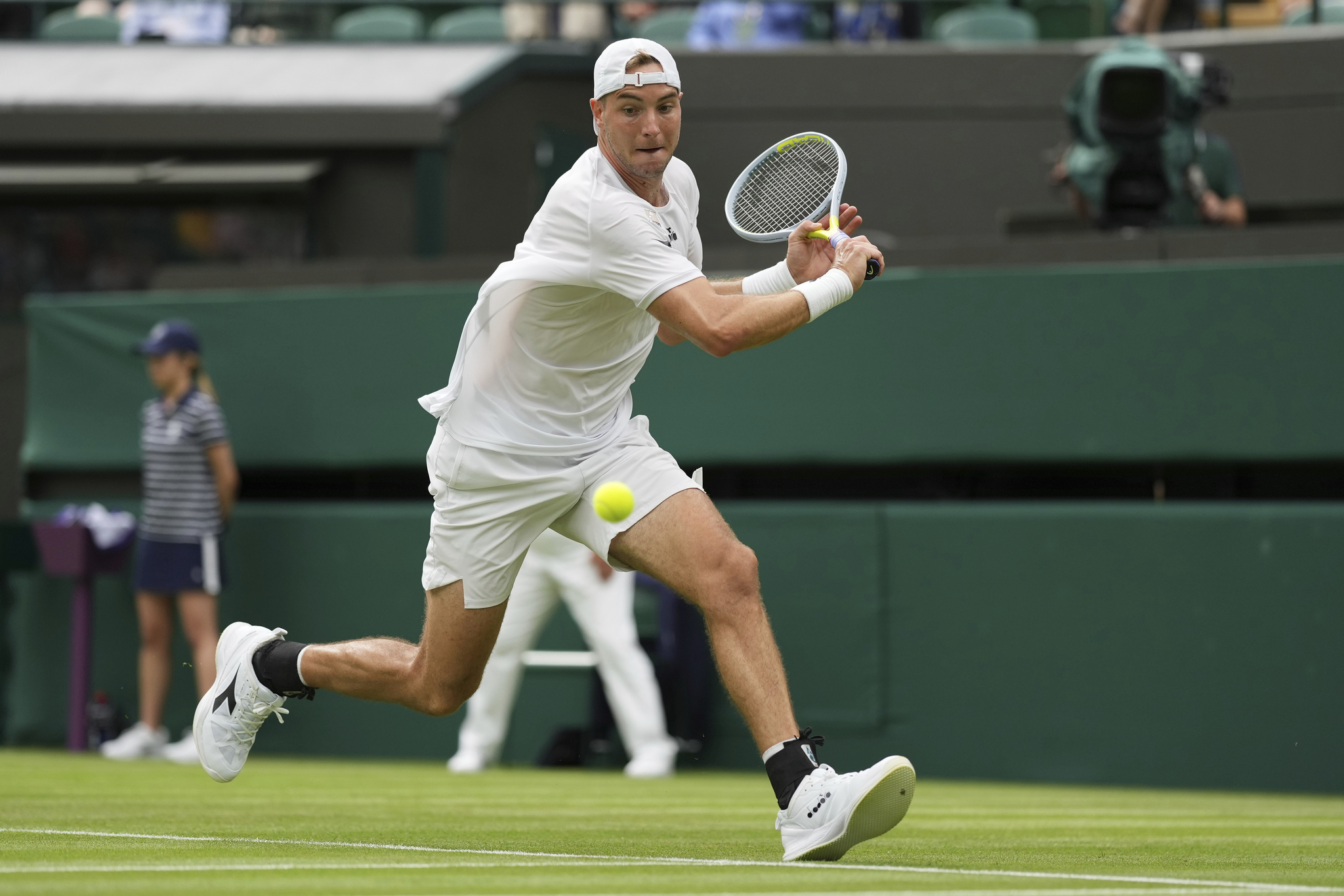 Germany's Jan-Lennard  lt;HIT gt;Struff lt;/HIT gt; returns the ball to Spain's Carlos Alcaraz during their men's singles tennis match on day one of the Wimbledon tennis championships in London, Monday, June 27, 2022. (AP Photo/Alberto Pezzali)