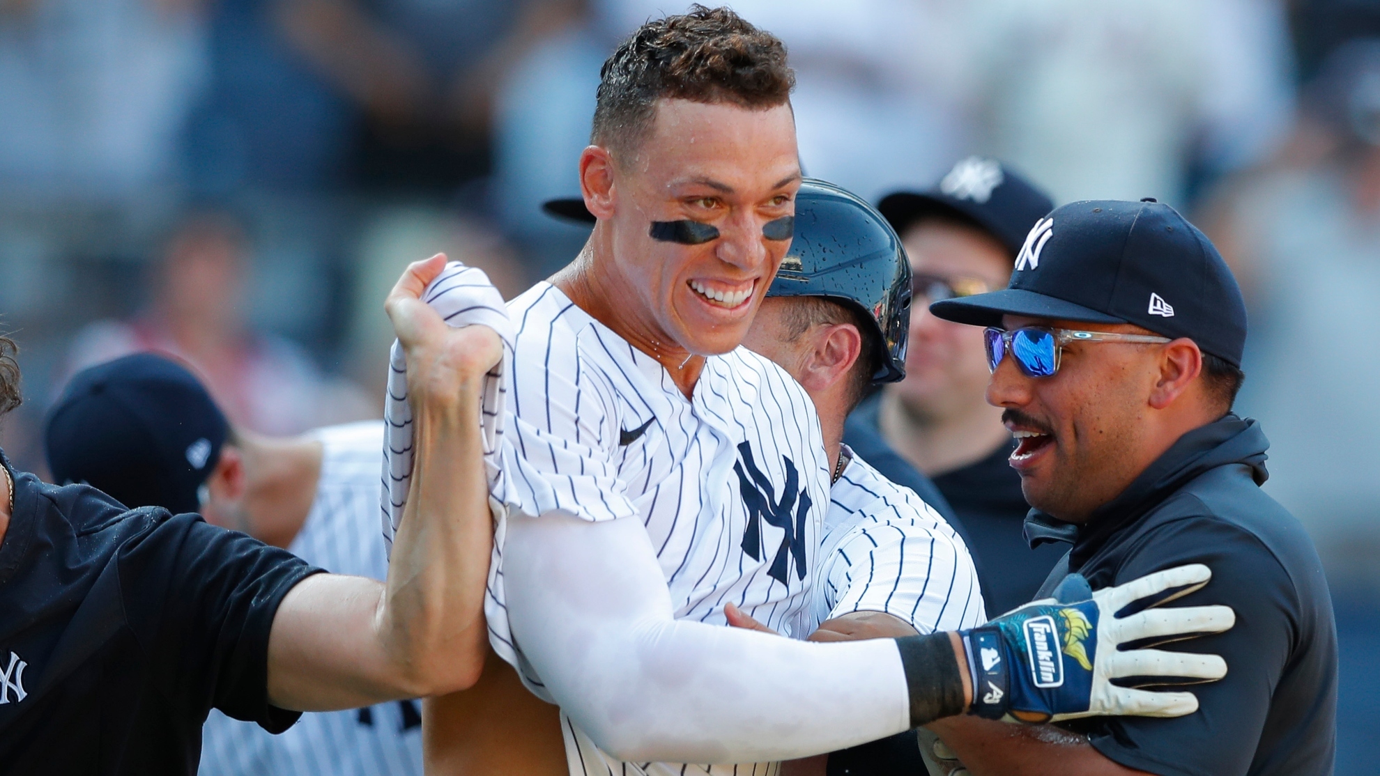 New York Yankees' Aaron Judge, center, and starting pitcher Nestor Cortes, right, celebrate after defeating the Houston Astros in the 10th inning of a baseball game